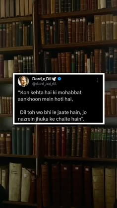 a man is sitting in front of a bookshelf with a tweet on his face