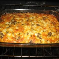 a casserole in an oven with cheese and meat