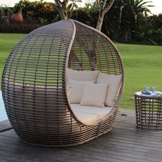 an outdoor wicker chair and table on a deck