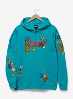 a blue hoodie with cartoon characters and flowers on the front, hanging from a hanger