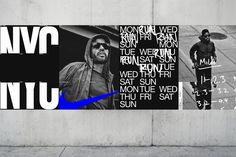 two posters on the side of a building, one with a blue nike logo and another with an image of a man holding a skateboard