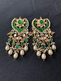 *It's Handmade Indian Ethnic Kundan Earrings with Green color combination. *It's made from Silver n Copper with Green N Pink Stones Settings and Beaded with Pearls with 22k gold Plating as shown in picture. *It is Pure Ethnic Look with Antique Touch and 2.7 inches Long. *Our all jewelry is made from semiprecious stones and beads. *WARRANTY: ITS GENUINE HANDMADE JEWELRY AND WE ARE GIVING LONG LIFE WARRANTY FOR OUR ALL ITEMS. All of our Kundan Jewelry is 100% handmade with ancient Kundan stone set Earring Indian, Stud Earrings Unique, Indian Gifts, Polki Earrings, Bridal Jewelry Collection, Potli Bags, Polki Jewellery, Pakistani Jewelry, Kundan Earrings