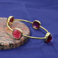 Women Gold Plated Bangle, Pink Tourmaline Gemstone Bangle, Handmade Bangle, Party Wear Bangle, Cushion Bangle, Statement Bangle Description : ~ Material : Brass & Gemstone ~ Gemstone : Pink Tourmaline Hydro ~ Stone Size : 10 x 10 mm Approx ~ Weight : 11.87 Gram Approx ~ Setting Type : Bezel ❣❣ Handmade Item ❣❣ **Made to Order** » G EM S T O N E D E T A I L « **Gemstone structure may vary from the image as two gemstones do not have the same structure** If you want to see the picture of gemstone, Gemstone Bangle Bracelets, Unique Bangle, Stackable Bangles, Simple Bangle, The Bangles, Gemstone Bangle, Hammered Earrings, Gold Plated Bangles, Jewelry Dainty