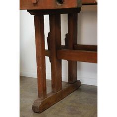 an old wooden table with two drawers on it