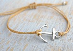 Silver or Gold Anchor Bracelet with Bead Accents. This string bracelet is a great for everyday wear. Think of the ocean and everything nautical when you wear this! A great gift idea for the nautical person in your life! BRACELET DETAILS - Silver or Gold Anchor Charm (measures 3/4 inch) - Fully adjustable to ensure perfect fit - Bead accents on ends for added sparkle and dangling look - Multiple Color options available! This bracelet has a great layered look and can be worn with our other bracele Silver Nautical Bracelets As A Gift, Adjustable Anchor Bracelets For Beach, Handmade Adjustable Nautical Bracelets, Handmade Nautical Adjustable Bracelets, Nautical Anchor Bracelets As Gift, Nautical Anchor Bracelet As Gift, Nautical Anchor Bracelet Gift, Silver Anchor Bracelet Gift, Adjustable Nautical Bracelets For Everyday