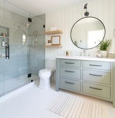 a bathroom with a sink, toilet and shower in it's own area next to the bathtub