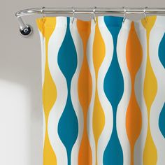 an orange, yellow and blue shower curtain hanging from a metal rod