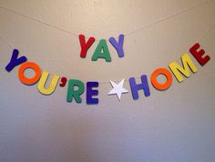 a banner that says you're home hanging on the wall