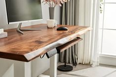 a computer monitor sitting on top of a wooden desk