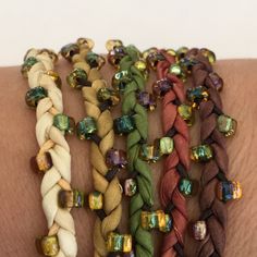 several different colored bracelets on someone's arm