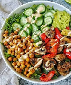 a white bowl filled with vegetables and dressing