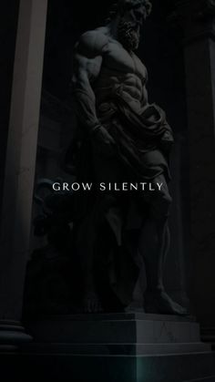 a statue with the words grow silently on it in front of an image of a man