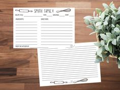 two notepads sitting on top of a wooden table next to a potted plant