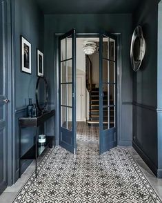 a hallway with blue walls and black doors