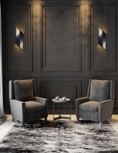 two chairs sitting next to each other in front of a wall with decorative paneling