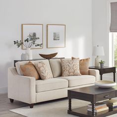 a living room scene with focus on the couch and coffee table in the foreground