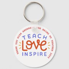 a keychain with the words teach love inspire written in orange and blue on it