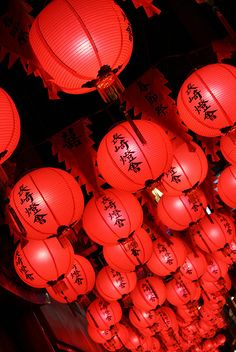 many red lanterns are hanging from the ceiling