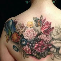 a woman's back with flowers and butterflies on it