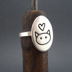 This is so simple and so cute! I hand make this ring in my Oakland studio. The top of the ring measures 3/4 of an inch tall and the entire ring is solid sterling silver. If the whole sizes in the drop down menu don't match your size send us your ring size in notes to seller at checkout. All rings are made to order and take about a week before we send them out. To see the matching necklace go here: https://www.etsy.com/listing/198777553/love-me-love-my-cat-necklace-sterling?ref=shop_home_active_7 Handmade Cute Sterling Silver Rings, Cute Handmade Sterling Silver Rings, Adjustable Sterling Silver Cat Design Rings, Silver Cat Ring, Sterling Silver Cat, Cat Ring, Silver Cat, Cat Necklace, Matching Necklaces