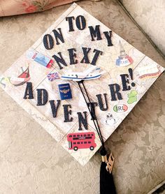 a decorated graduation cap that says on to my next adventure is sitting on a couch