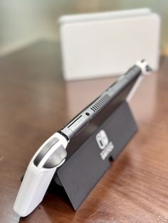 an electronic device sitting on top of a wooden table