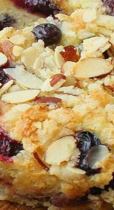 a close up of a muffin with blueberries and almonds