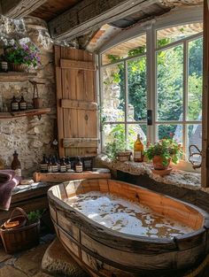 an old wooden bathtub in a stone walled room with open windows and potted plants