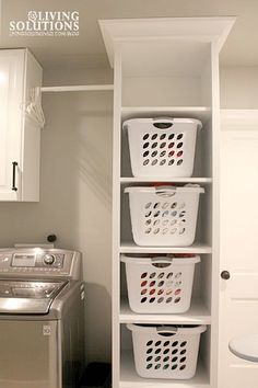 a washer and dryer sitting next to each other in a small laundry room