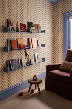 a living room filled with furniture and bookshelves next to a wall mounted book shelf