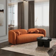 an orange couch sitting on top of a rug in a living room next to a window