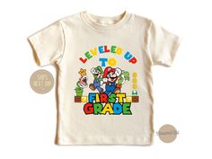 🎉 Welcome to SoGoodKids on Etsy! ✨ Step into the magical world of Super Mario with our delightful collection of custom-designed shirts! 🍄 Whether you're planning a Super Mario-themed birthday party 🎈 or simply want to add a dash of nostalgia to your family's wardrobe, our Super Mario Birthday Shirts are the perfect choice. Each shirt is crafted with love and attention to detail, featuring iconic characters and vibrant designs that will bring joy to any Mario enthusiast.  Available in a range End Of School Year Graphic Print Tops For Playtime, Themed Short Sleeve Tops For Playtime, First Grade Shirt, Designed Shirts, Super Mario Birthday, Mario Birthday, Magical World, School Shirts, Iconic Characters