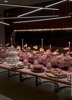 a table topped with lots of cakes and cupcakes