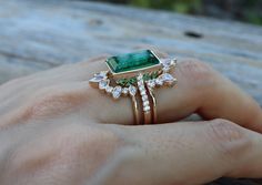 A Jaw-Dropping 3 Piece Bridal Ring Set features a Shimmery Large Lab-made 5ct Emerald/Rectangle Cut Emerald Faceted Engagement Ring paired with 2 Contour Wedding Bands handcrafted in 14k Solid Rose/Yellow/White Gold is simply divine! Our Lab-Made Emerald Engagement Ring Set will have her swooned as it is a very unique ring set. It comes with a Ring Box ready for gift-giving.(r-set-101) Engagement Ring Info ---------------------- Solid 14k Rose /Yellow/White Gold Lab Made Green Emerald 5ct Emeral Wedding Bands For Rectangle Rings, Green Emerald Engagement Ring With Band, Large Emerald Engagement Ring, Gold Emerald And Diamond Engagement Ring, Unique Emerald Wedding Rings, Rectangle Emerald Ring, Emerald Ring Set, Trillion Cut Emerald Ring With Diamond For Wedding, Trillion Cut Emerald Diamond Wedding Ring