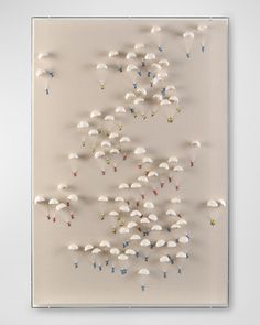 an art work with white umbrellas and stars on the bottom, in front of a beige background