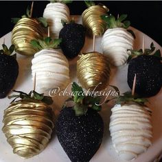 chocolate covered strawberries are arranged on a white platter with gold dipped strawberries