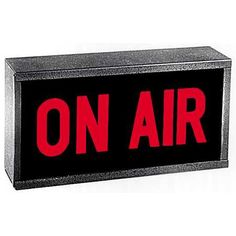 an on air sign with the word on it in red and black letters, against a white background