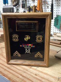 a wooden frame with several medals on it