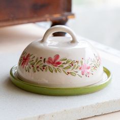 a ceramic covered dish sitting on top of a counter