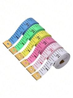 measuring tape in different colors and sizes are on the white background, with one ruler at the bottom