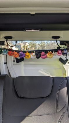 the back seat of a car with various items hanging from it's roof rack