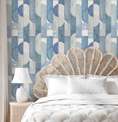 a bedroom with blue and white wallpaper, wicker headboard and rattan bed