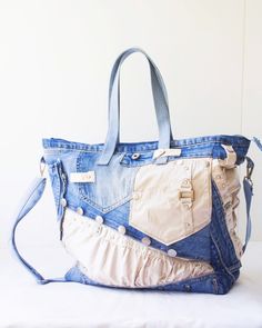 a blue and white purse sitting on top of a bed next to a wall,