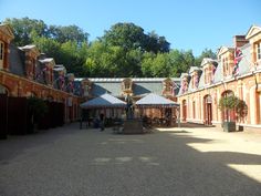 the courtyard of an old building with flags on it