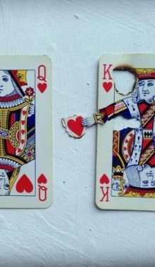 two playing cards that have been made to look like king and queen of spades