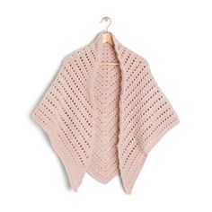 a pink knitted shawl hanging on a wooden hanger