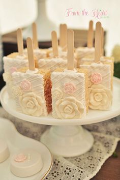 there is a cake that has been decorated with flowers and sticks on top of it