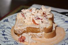 a plate with some food on it sitting on top of a blue and white table cloth