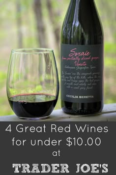 a bottle of red wine next to a glass with the words, 4 great red wines for under $ 10 00 at trader joe's