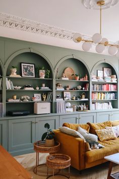 a living room filled with furniture and bookshelves